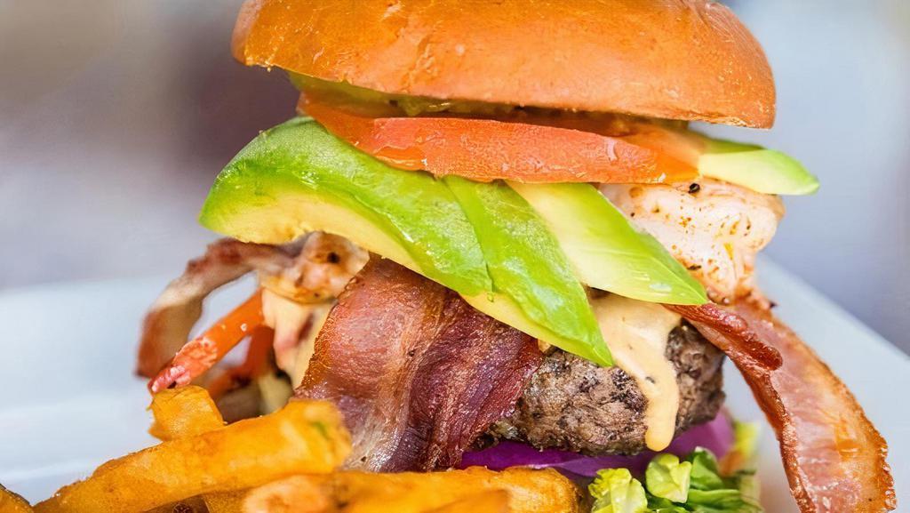 Surf & Turf Burger · Shrimp sautéed in our salsa with fajita mix, Bacon, Avocado, and lettuce on our fresh, free range & grass fed Angus beef patty. Topped with our homemade Tequila infused queso.
