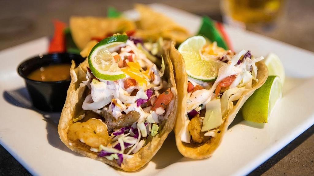 Fish Tacos · 2 grilled or fried Mahi Mahi fish tacos served with pico de gallo, Baja white sauce, cabbage, shredded cheese and lime