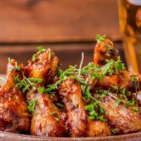 The Honey Buffalo Wings · Honey buffalo sauce tossed on wings with customer's choice of bone-in or boneless! Served wi...