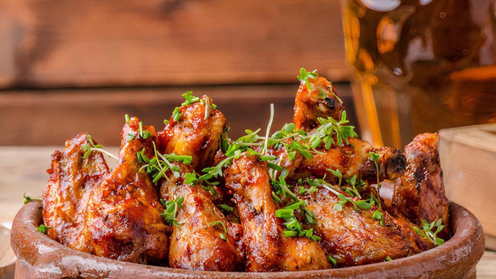 The Honey Buffalo Wings · Honey buffalo sauce tossed on wings with customer's choice of bone-in or boneless! Served with choice of ranch, bleu cheese, BBQ, honey mustard or sweet & sour side sauce!
