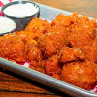 Vegan Cauliflower Wings · House battered cauliflower served with vegan blue cheeze.. your choice of BBQ or Buffalo coa...