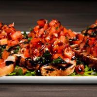 Tomato Basil Bruschetta · Tossed with garlic and extra virgin olive oil and served with aged balsamic and house made c...