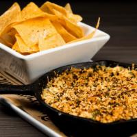 Jalapeno Artichoke Dip · Jalapenos, Artichokes, Cream Cheese topped with Bread Crumbs and Parmesan. Served With A sid...