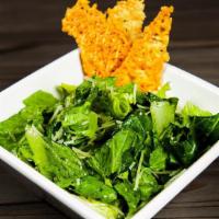 Side Caesar Salad · Hearts of romaine with baked parmesan crisps and shredded parmesan tossed in our house made ...