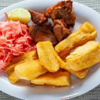 Yuca Con Chicharron · FRIED CASSAVA AND CHUNKS OF PORK WITH MARINATED CABBAGE.