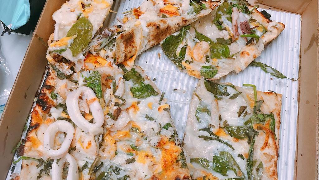 Seafood Lovers Pizza · Roasted garlic cream, basil, spinach, shrimp, crab, calamari, mozzarella, provolone and cheddar.