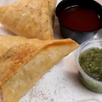 Vegetable Samosa · Pieces of crisp pastry filled with mildly spiced potatoes and peas.