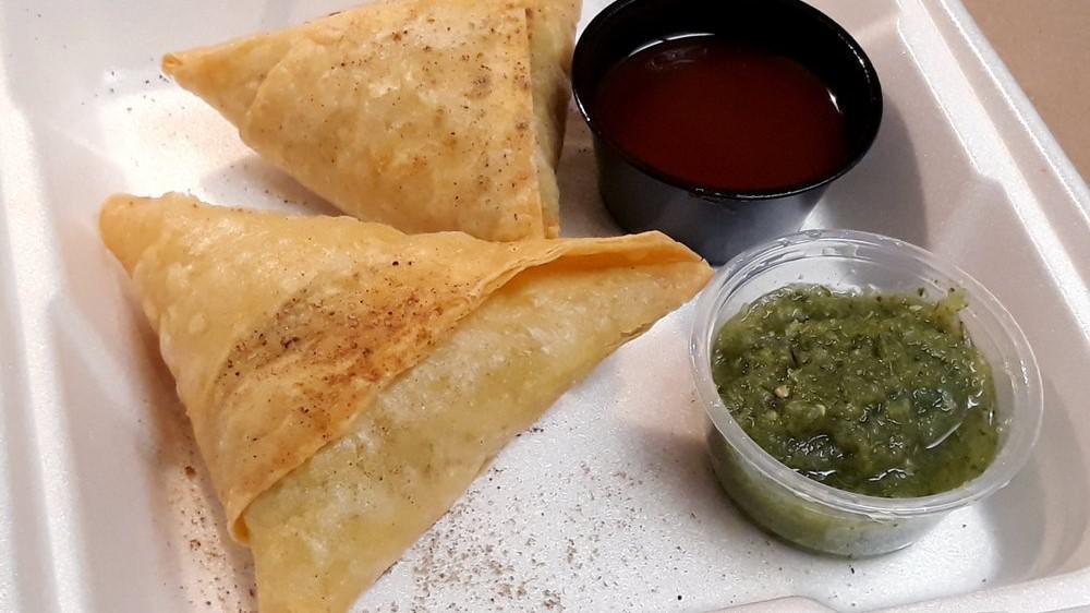 Vegetable Samosa · Pieces of crisp pastry filled with mildly spiced potatoes and peas.