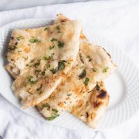 Paneer Kulcha · Leavened bread filled with farmer's cheese and peas.