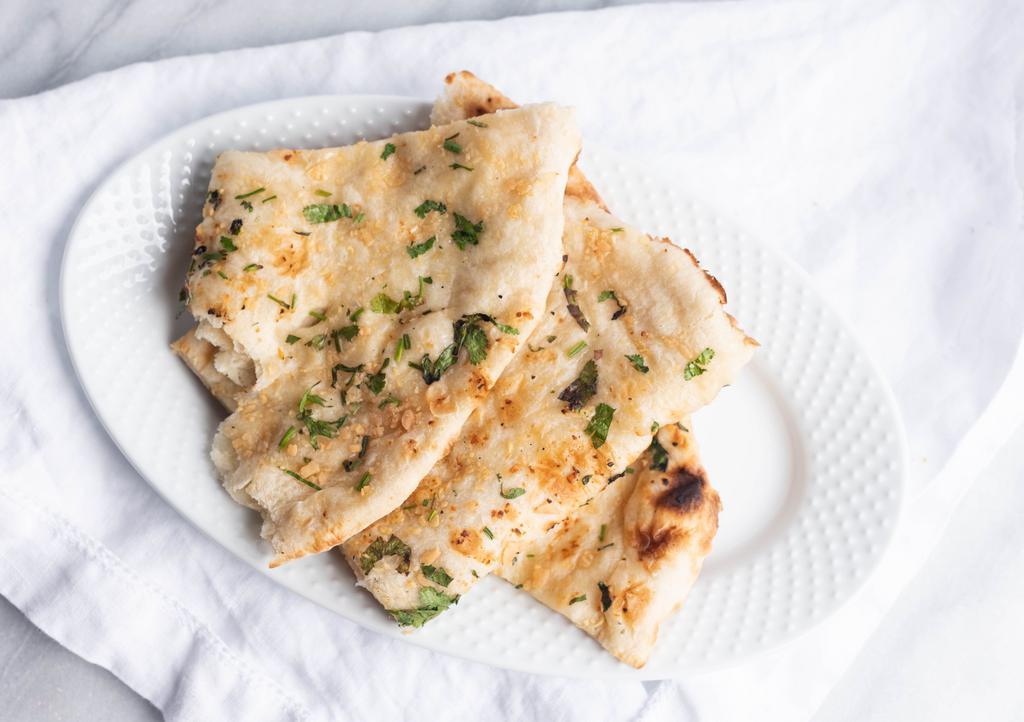 Paneer Kulcha · Leavened bread filled with farmer's cheese and peas.