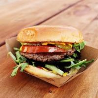 Backyard Burger · Impossible Patty, Ketchup, Yellow Mustard, Tomato, Mixed Greens, & Pickles Served on Vegan B...