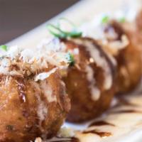 Takoyaki · Deep fried flour ball filled with octopus. Six piece, sprinkled with bonito fish flakes, may...