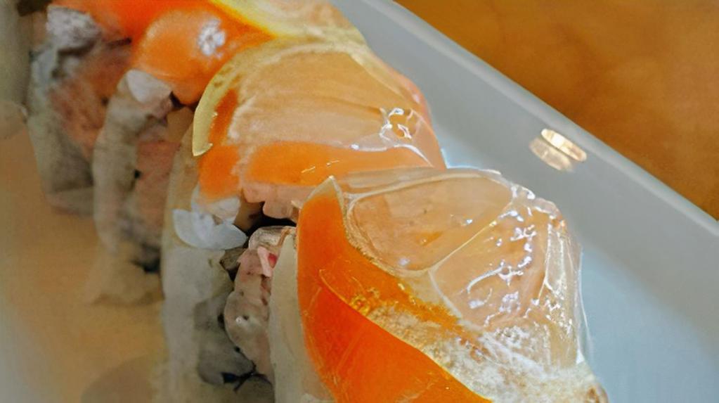 Sake Lemon Roll · crab meat, avocado, Japanese mayo inside, topped with fresh salmon and thin sliced fresh lemon.