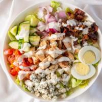 The Smoked Cobb · Iceberg lettuce, tomatoes, onions, cucumbers, blue cheese, hard boiled egg, candy bacon and ...