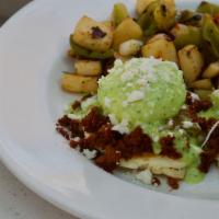 Mexicali Benedict · Poached eggs, soy chorizo, cotija cheese, roasted poblano hollandaise - over corn cakes.