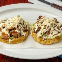 Sopes · Handmade thick corn tortillas with raised edges with grilled chicken, topped with lettuce an...