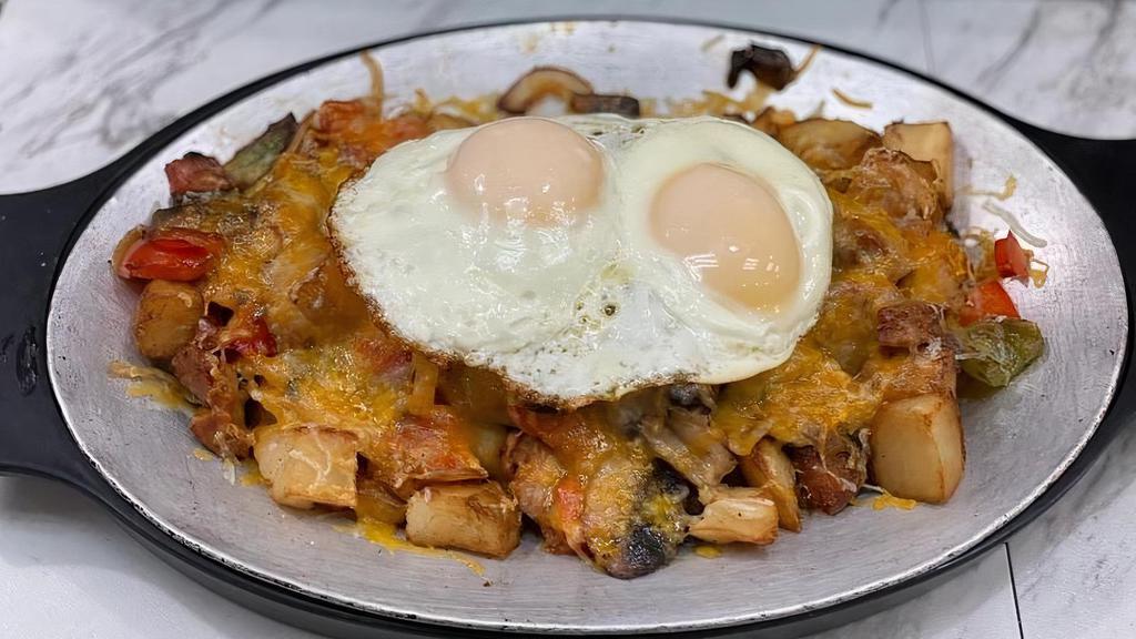 Breakfast Skillet · SERVED WITH SAUSAGE, TOMATO, PEPPERS ONION, MUSHROOMS, HOME FRIES, JACK CHEESE ANd 2 EGGS ON TOP