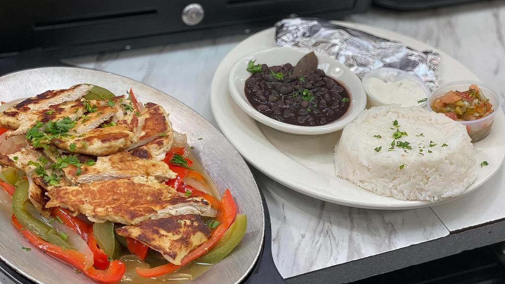 Grilled Chicken Fajitas · Served with peppers, onions, side of rice, black beans, sour cream . and Pico de Gallo.