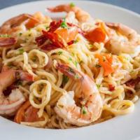 Shrimp Scampi Pasta · Fresh pasta, tossed with jumbo shrimp, sautéed with tomatoes, onions . and garlic, in a whit...