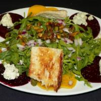 Roasted Beet · Red and gold arugula, pistachios, red onion, your choice of goat or gorgonzola cheese, tosse...