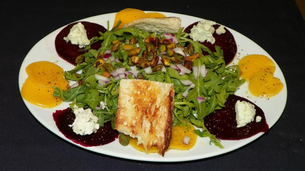 Roasted Beet · Red and gold arugula, pistachios, red onion, your choice of goat or gorgonzola cheese, tossed with lemon vinaigrette.