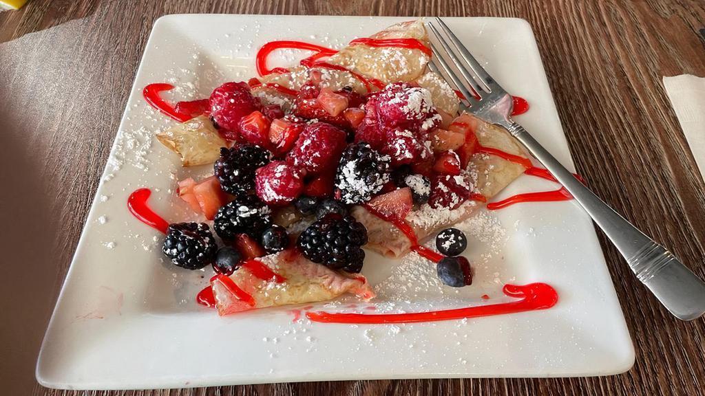 Fruit Rush Crêpes · Fresh strawberries, blackberries, blueberries and raspberries stuffed into our crêpes, topped with more berries, and powdered sugar.