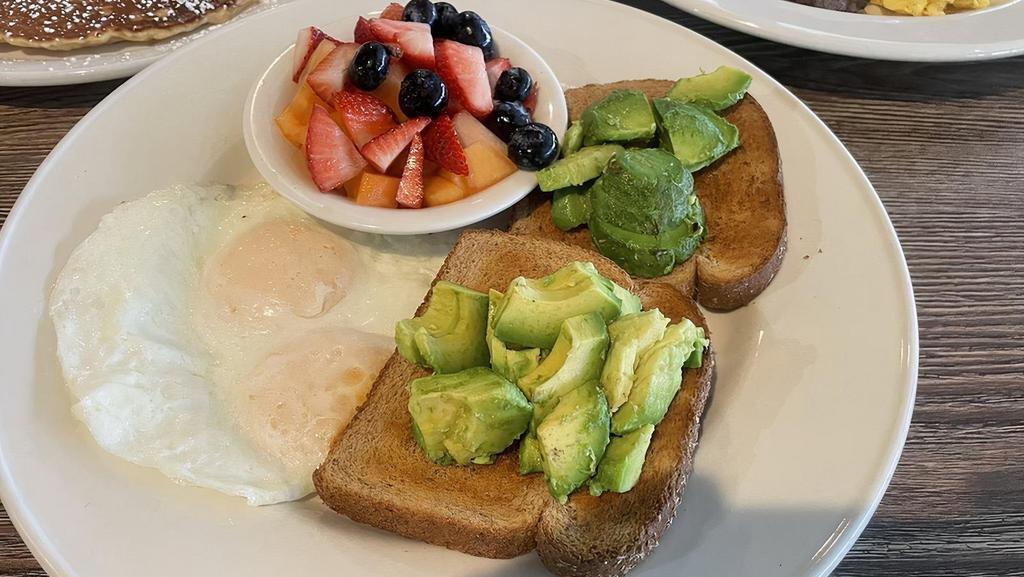 Avocado Toast · Fresh avocado served on your choice of white, wheat or sourdough. Served with two eggs and fresh fruit.