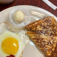 Club Breakfast · Two triangles of French toast, one egg and bacon or sausage patties.