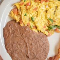 Huevos A La Mexicana · Two large eggs scrambled with onion, tomato and jalapenos. With Refried Beans