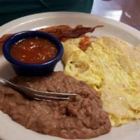 Migas · Cut and fried corn tortilla with scrambled eggs, cheese, salsa. With Refried Beans
