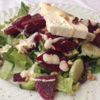 Beet Salad · Fresh marinated beets, cucumbers, walnuts, goat cheese, romaine lettuce, house dressing.