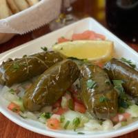 Dolamdes Yialanzi (Vg) · Homemade Grape leaves stuffed with rice, herbs, olive oil, and lemon juice. (4-5 PIECES)