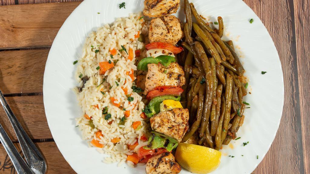 Chicken Kebab · Marinated chicken breast skewer with onions, green peppers grilled and served over rice pilaf
