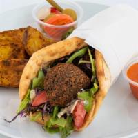 Falafel Wrap · Falafel, salad, tahini, red sauce, garlic dressing and pickles all wrapped up in a soft pita...