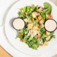 Caesar Salad · Crisp romaine lettuce. Tossed in Caesar dressing and topped with parmesan cheese and Caesar ...