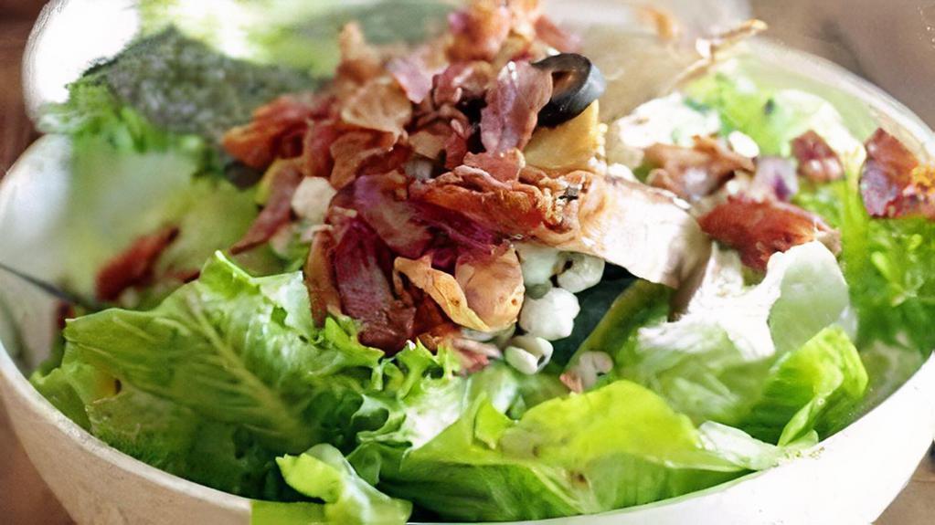 Boston Salad · Baby iceberg lettuce, tomatoes, fried bacon, blue cheese dressing.