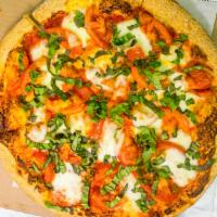 Margarita Pizza · Very light tomato sauce, fresh mozzarella, tomatoes, basil, drizzled with olive oil.