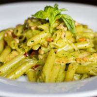 Penne Pasta · Wood Fired chicken breast cooked in a pesto cream sauce with sun dried tomatoes and pine nuts