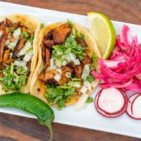 Taco Al Pastor (Order Of 2) · Pork, served with onions, cilantro, radish, lemon, and salsa. / Servido con cebolla, cilantr...