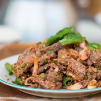 Crying Tiger** · Thai spicy. Sliced grilled flank steak tossed with hot peppers, shallot, mint, fish sauce, l...
