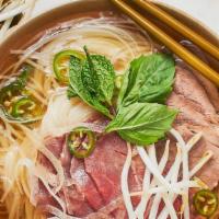 Pho · Vietnamese-style beef noodle soup with thinly sliced ribeye and roasted beef sided with bean...