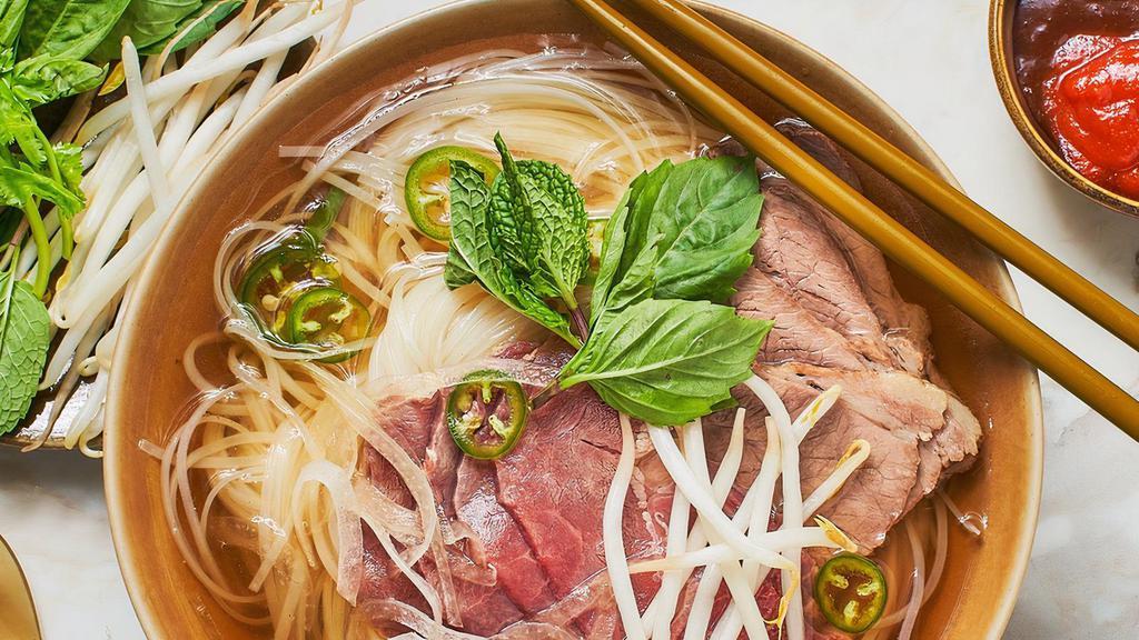 Pho · Vietnamese-style beef noodle soup with thinly sliced ribeye and roasted beef sided with bean sprout and basil.