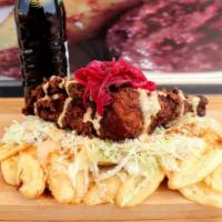 Tajadas De Guineo, Platano O Maduro · Fried plantain of choice topped with meat of choice, cabbage, special sauce, and special dre...