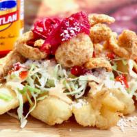 Yuca Sancochada Con Chicharron (Fried) · Yucca root boiled or fried with special seasoning topped with fried pork pieces, pickled cab...