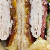 Turkey Club Sandwich · Turkey, crisp applewood bacon, Cheddar cheese, tomato, red onion, mayonnaise, dijon mustard,...