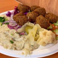 Falafel Platter · Ground chickpeas balls deep fried in vegetable oil. Served on a bed of rice with hummus, sal...