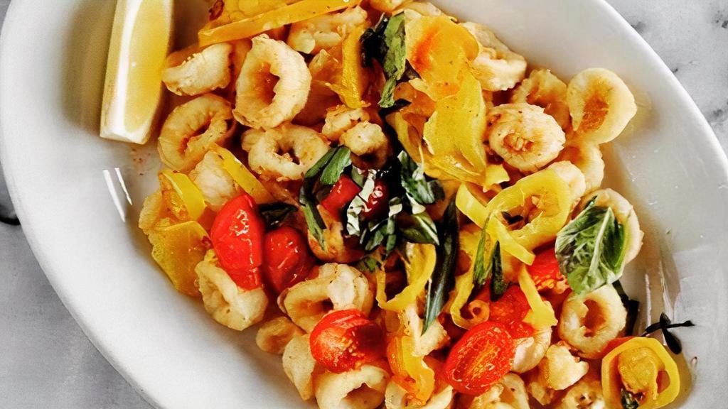 Rhode Island Calamari · Fried squid rings tossed with garlic, EVOO, chopped tomatoes, and pepper rings.