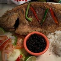 Mojarra Frita - Fried Fish · A whole fried tilapia topped with sauce, onions, tomatos, green pepper, served with rice, be...