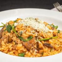 Risotto Mignon · Hand-cut CAB filet tips simmered in a Marsala wine sauce with mushrooms, baby spinach, and P...