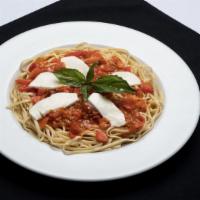 Linguini Caprese · Tomatoes and onions simmered in a garlic basil white wine, topped with fresh Buffalo mozzare...